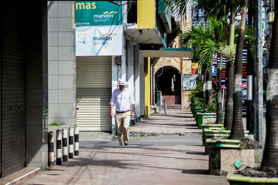 Woman walking in corridor of building