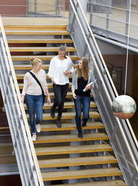 Three university student on stairs