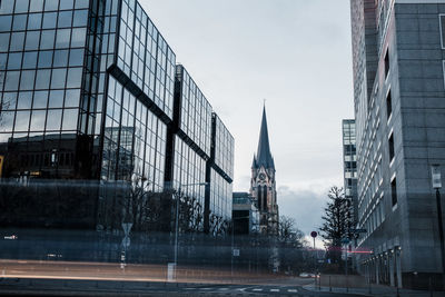 City street by buildings against sky