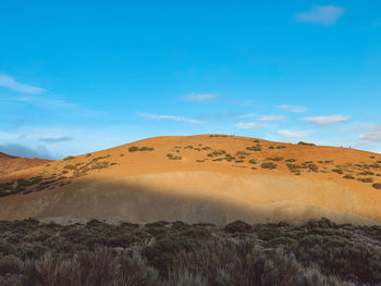 Scenic view of arid landscape against sky