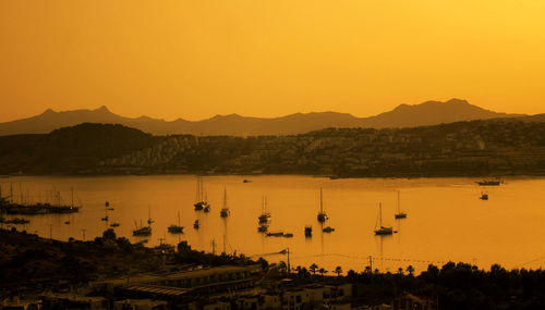 View of boats in water at sunset