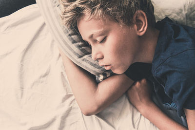 Boy sleeping on bed