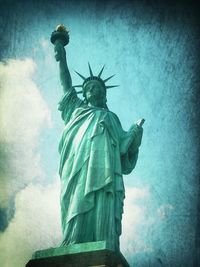 Low angle view of statue of liberty against sky