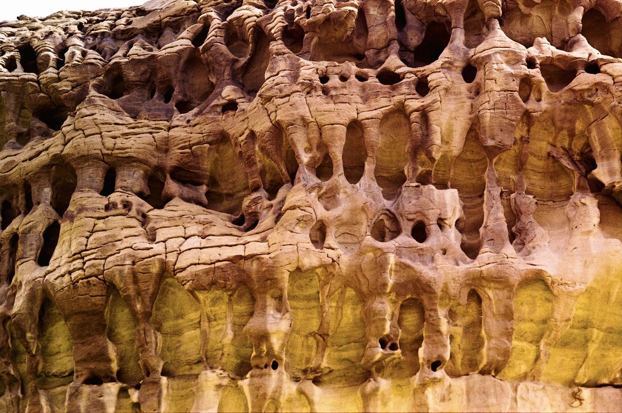 LOW ANGLE VIEW OF ROCK FORMATIONS IN A WATER