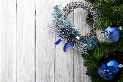 Close-up of christmas tree and wreath on table