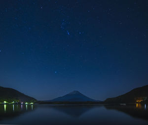 Starry sky over mount fuji on a clear night from lake shoji, yamanashi prefecture, japan