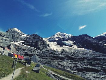 Scenic view of mountains against blue sky