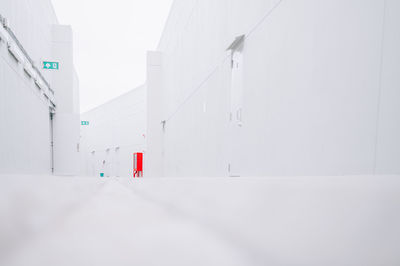 White wall with building in snow