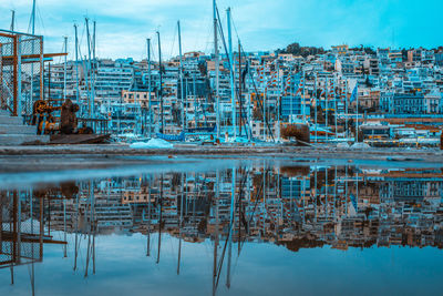 Reflection of built structure in lake against sky