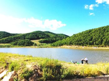 Scenic view of lake with mountains in background