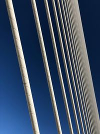 Low angle view of metallic structure against clear blue sky