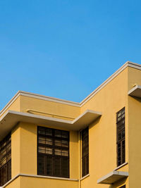 Low angle view of building against clear blue sky