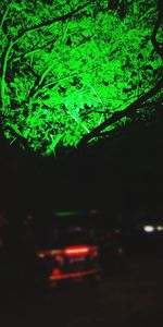 Illuminated street in city at night