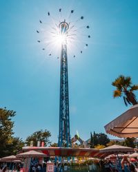 Low angle view of illuminated ferris wheel against sky