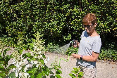 Senior woman watering the plants