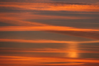 Beautiful sunset sky above clouds with dramatic light. cabin view from airplane