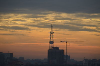 View of buildings against cloudy sky during sunset
