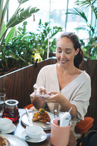 Woman sitting on table