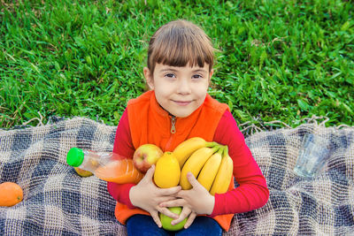 Portrait of cute boy holding fruit