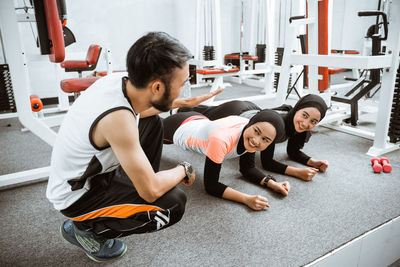 Side view of woman exercising in gym