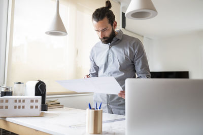 Rear view of man working in office