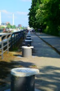 Close-up of metal structure by road in city against sky