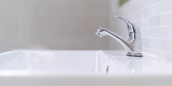 Close-up of faucet in bathroom