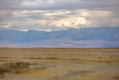 Scenic view of arid landscape against sky