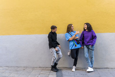 Young diverse friends talking outdoors on the street.