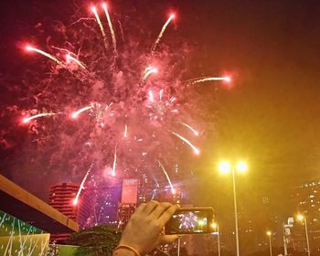 Low angle view of firework display at night