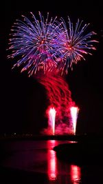 Low angle view of firework display at night