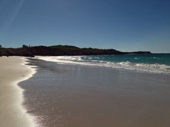 Scenic view of beach against clear sky