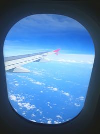 Aerial view of clouds seen through airplane window