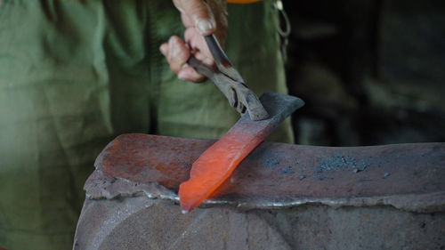 Red hot metal blank in the forge on the anvil. anvil in the forge