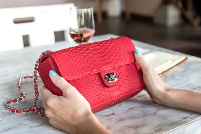 Midsection of woman holding red table