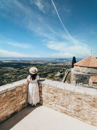 Woman standing against sky