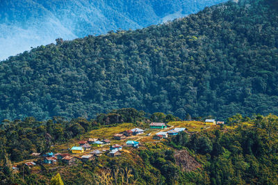 High angle view of trees and houses against mountains