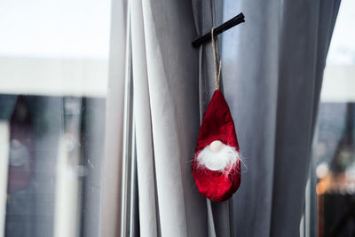 Close-up of christmas decorations hanging from window