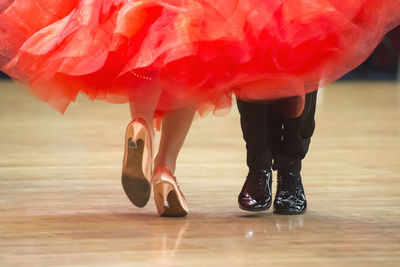 Low section of women wearing red shoes standing outdoors