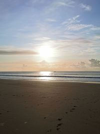 Scenic view of beach against sky during sunset