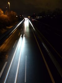 Light trails on road in city at night