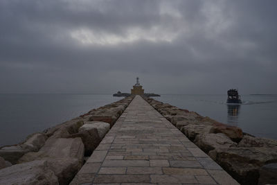 Lighthouse against cloudy sky