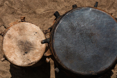 High angle view of old rusty wheel on wood