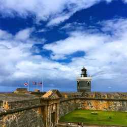 Lighthouse against cloudy sky