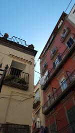 Low angle view of buildings against clear blue sky