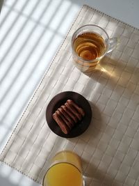 High angle view of drink and biscuit on table