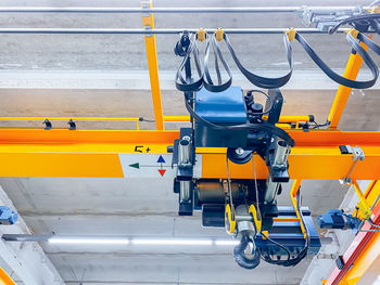 Overhead crane and machine inside factory building, industrial background.