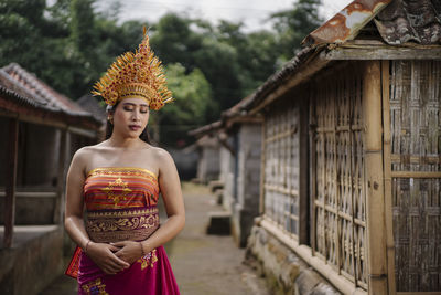 Young woman standing against temple