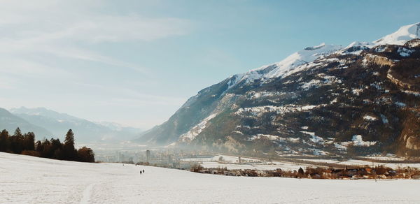 Scenic view of snow covered mountains against sky