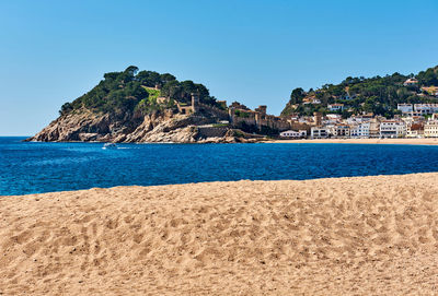 Scenic view of sea against clear blue sky